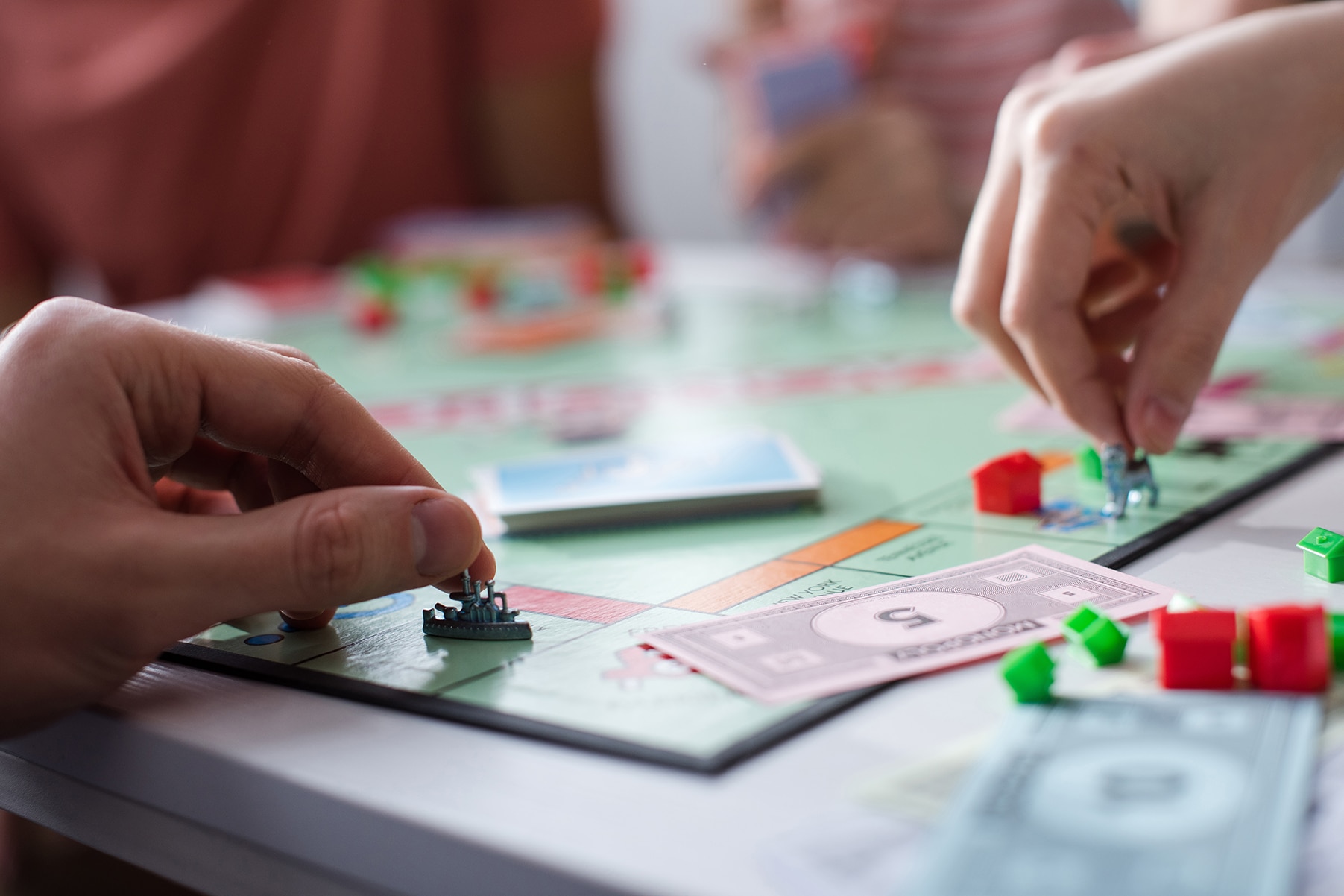 two people playing a monopoly game