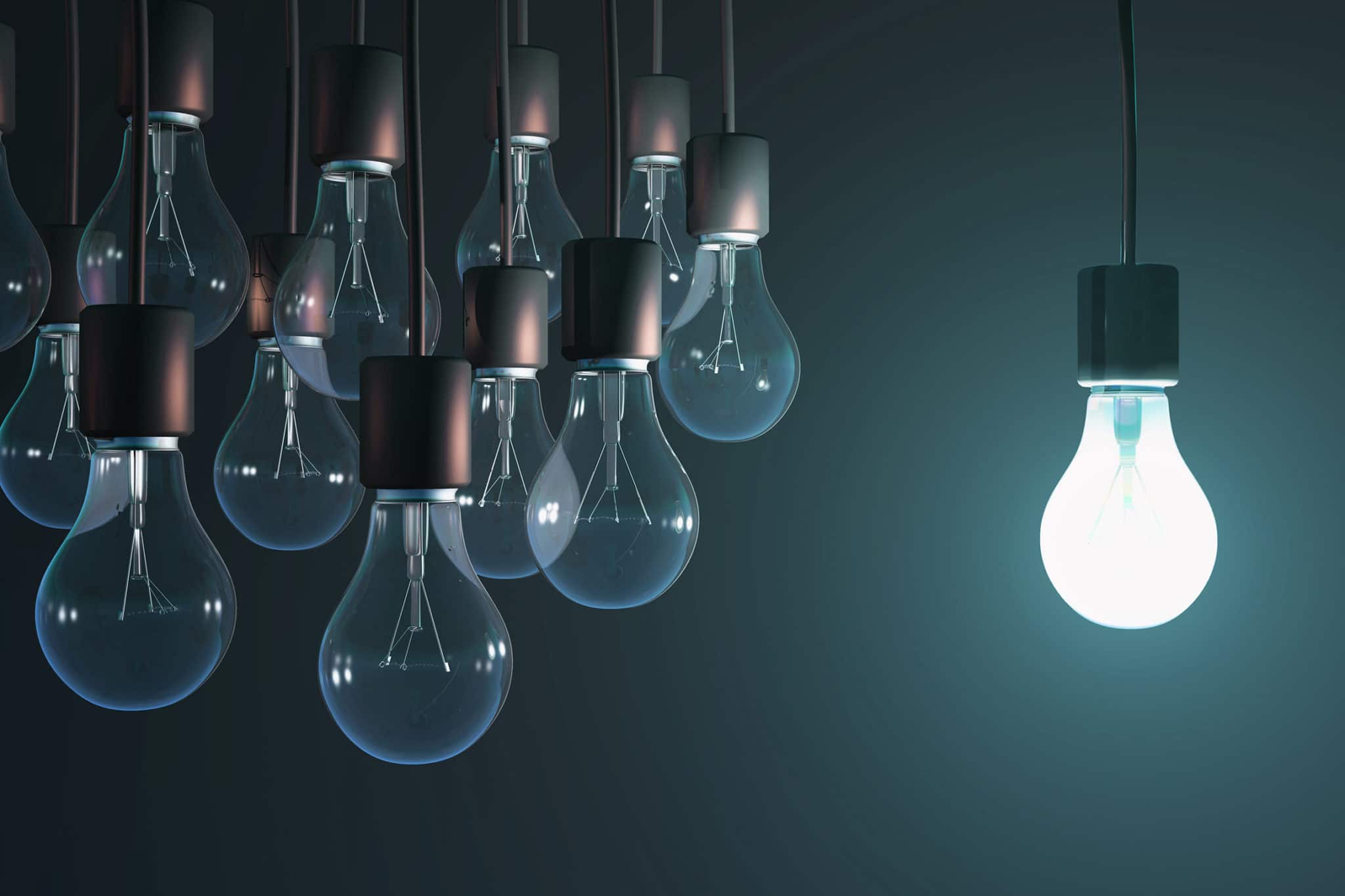 glowing lightbulb outside a group of dead lightbulbs